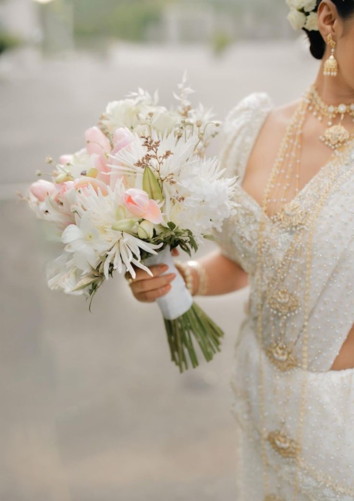 Bride in traditional Sri Lankan attire with floral bouquet